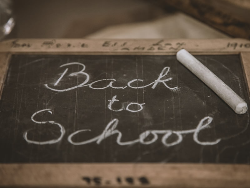 Back to School handwritten on a blackboard in chalk. Photo by Deleece Cook on Unsplash.