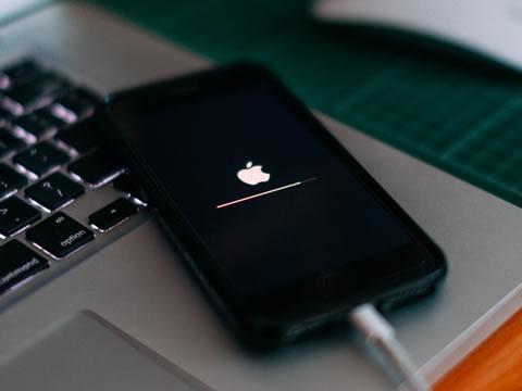 Apple iPhone plugged into a computer.