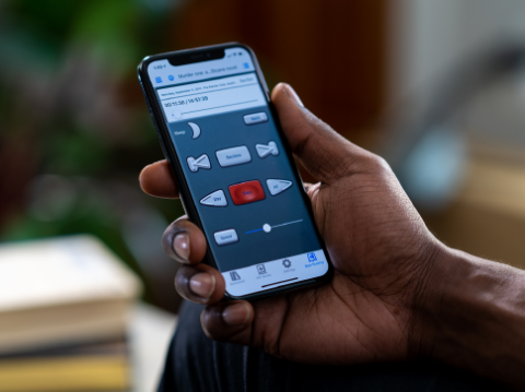 Hand holding mobile phone with BARD app showing.